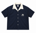 A navy blue short-sleeve camp collar button-up shirt with a cream collar, featuring a chest pocket with a white embroidered 'YHWH' logo and white buttons.